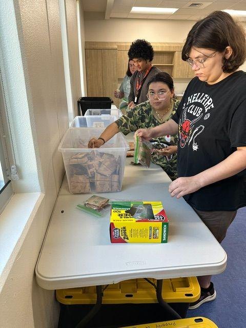 Young adults packing weekend food bags