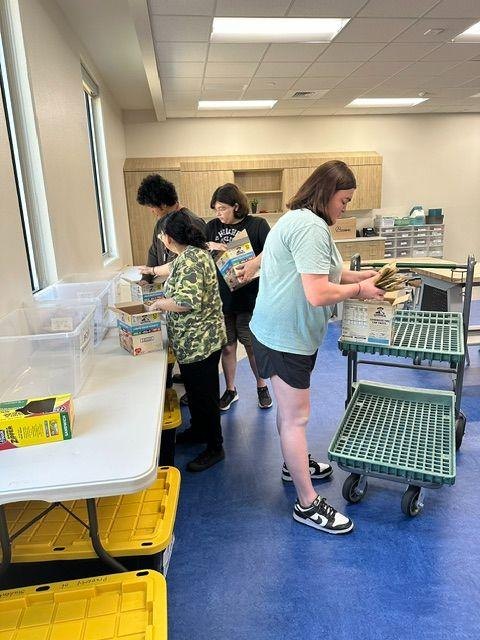 Nourish Ability young adults packing food bags